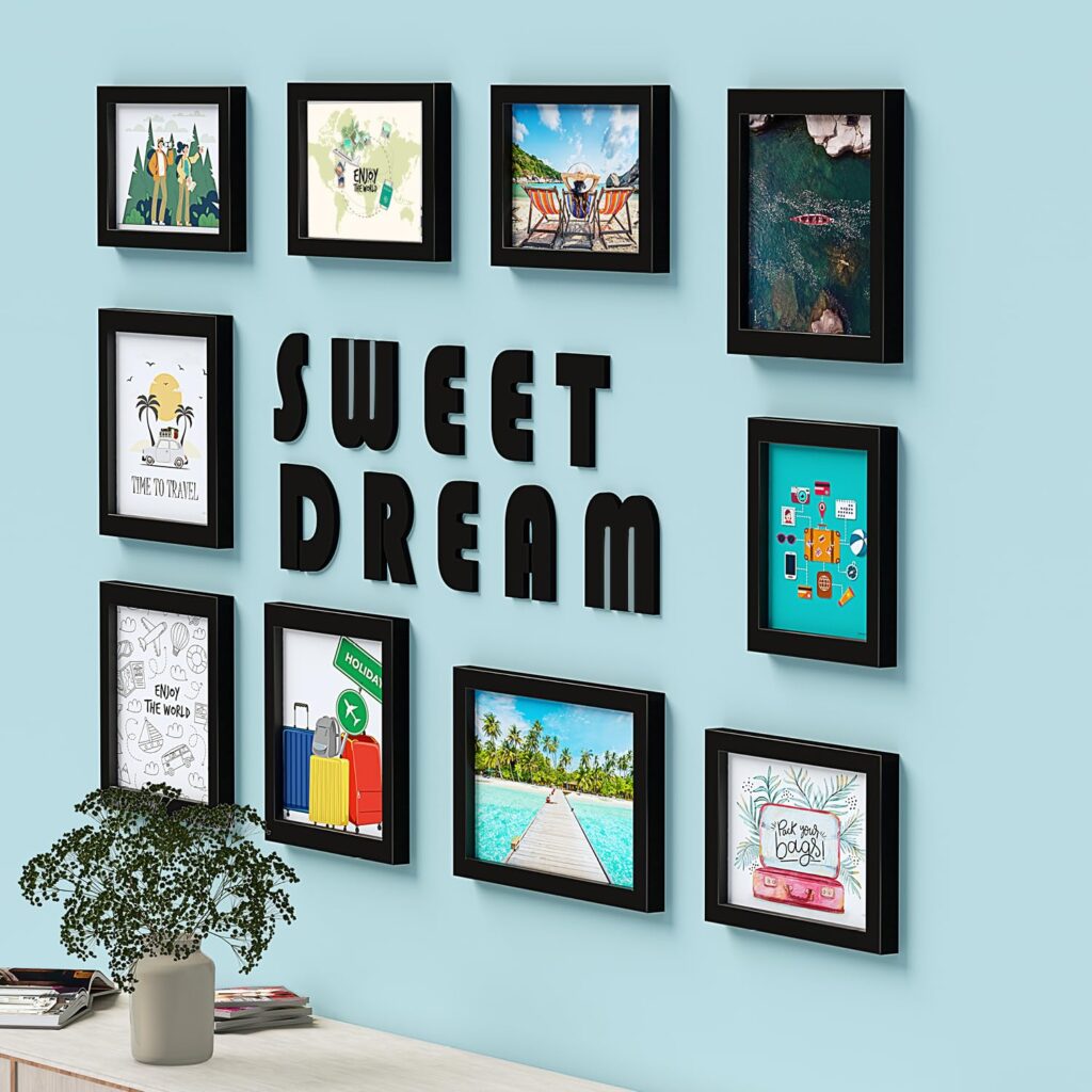 Modern wall decor featuring black photo frames with travel-themed artwork and “Sweet Dream” lettering on a blue wa