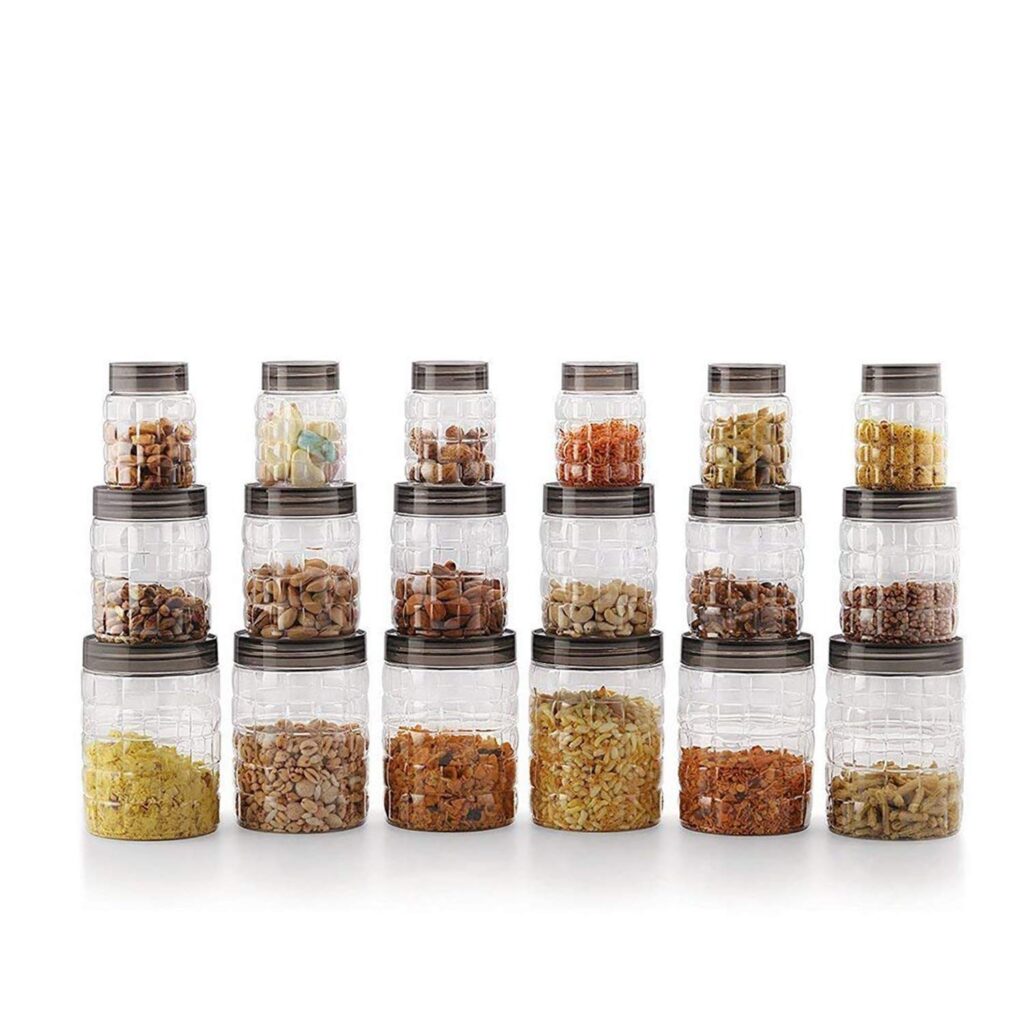smart kitchen hacks tools Set of transparent airtight kitchen storage containers filled with nuts, pulses, spices, and dry food items arranged in rows