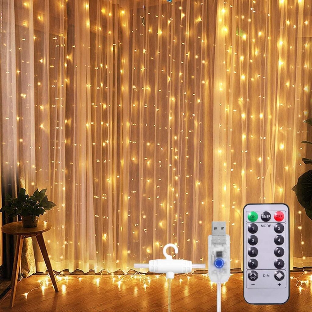Warm white LED curtain string lights hanging on sheer curtains with remote control and USB plug for home decoration